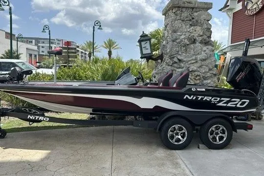 The Image of 2026 Nitro Z20 XL Pro boat on trailer, parked outdoors with scenic background. - 0