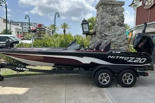 The Image of 2026 Nitro Z20 XL Pro boat on trailer, parked outdoors with scenic background. - 0