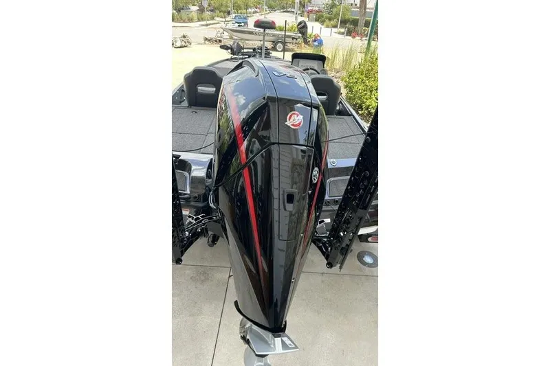 Slide: The Image of The image shows a black boat with a powerful outboard motor, sitting on a trailer. - 11