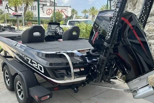 Slide: The Image of 2026 Nitro Z20 XL Pro boat with powerful engine, parked outdoors on a trailer. - 2