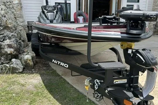 Slide: The Image of 2026 Nitro Z20 XL Pro boat on trailer, parked outdoors near stone wall. - 3