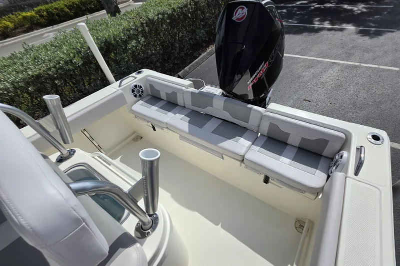 Slide: The Image of 2024 Mako 214 Center Console boat interior with seating and Mercury engine. - 16