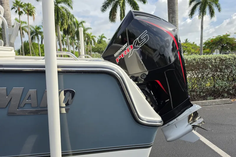 Slide: The Image of 2024 Mako 214 Center Console boat with Mercury Pro XS engine, parked near palm trees. - 20