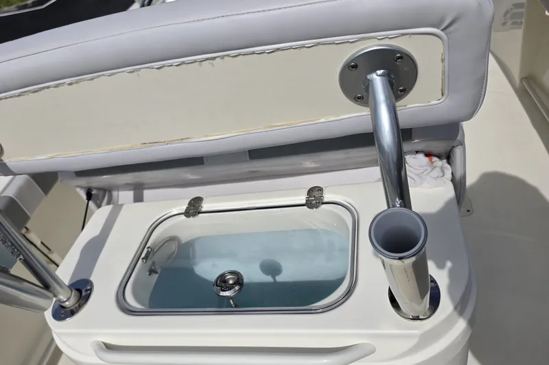 Slide: The Image of 2024 Mako 214 Center Console boat with open livewell and rod holder. - 18