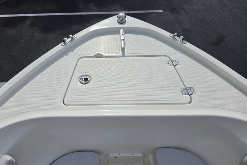 Slide: The Image of Bow view of 2024 Mako 214 Center Console boat, featuring storage hatch and cleats. - 5