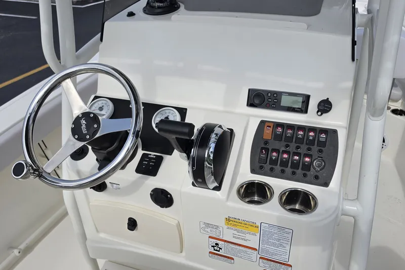 Slide: The Image of 2024 Mako 214 Center Console boat dashboard with steering wheel and control panel. - 9