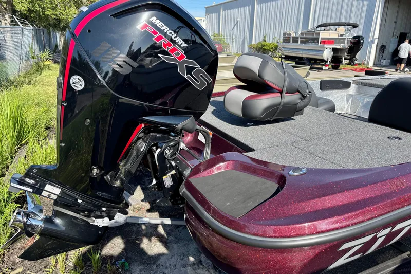 Slide: The Image of 2025 Nitro Z17 boat with Mercury Pro XS 115 engine, parked outdoors. - 2