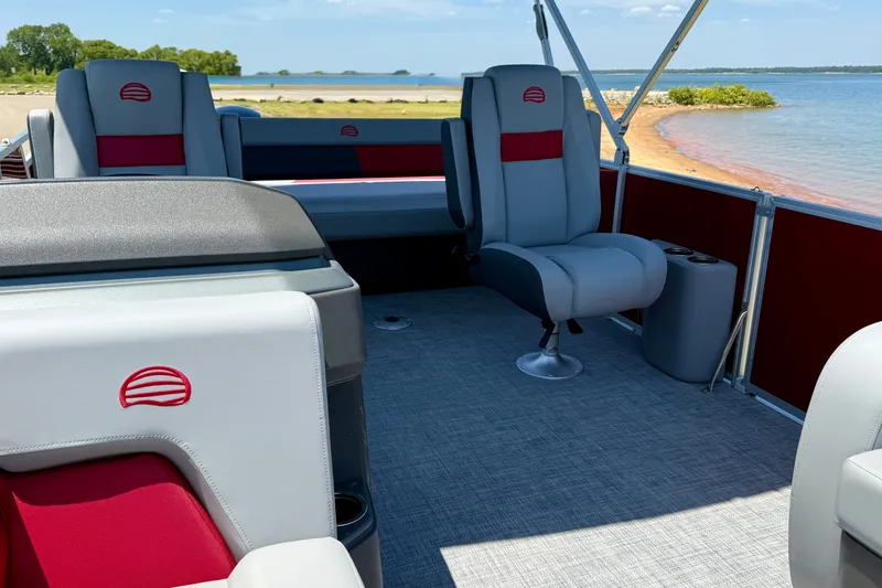 Slide: The Image of 2026 Sun Tracker Party Barge 22 RF DLX interior with lake view, featuring comfortable seating. - 11