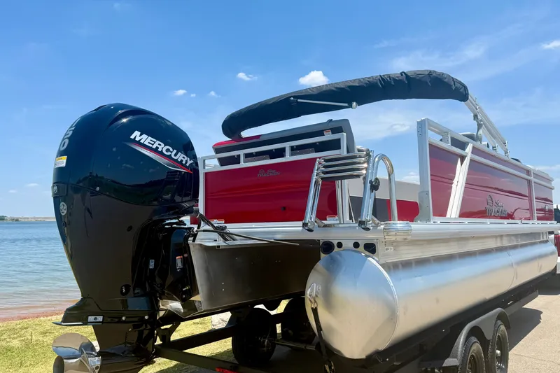 Slide: The Image of 2026 Sun Tracker Party Barge 22 RF DLX pontoon boat with Mercury outboard motor by a lake. - 5
