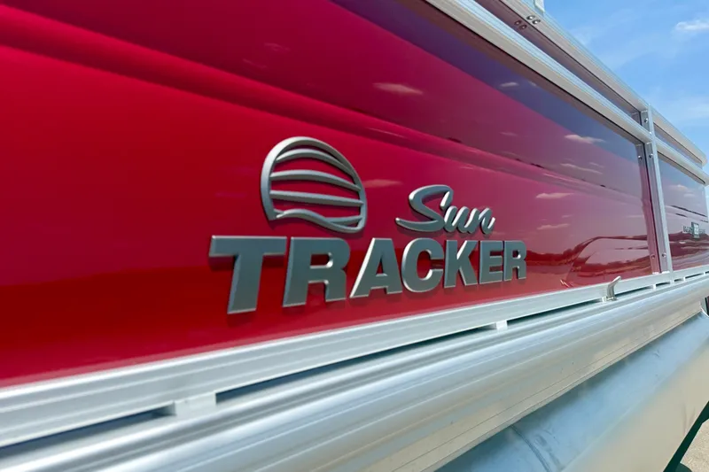 Slide: The Image of 2026 Sun Tracker Party Barge 22 RF DLX with red exterior and logo detail. - 3