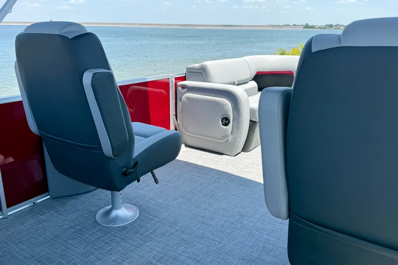 Slide: The Image of 2026 Sun Tracker Party Barge 22 RF DLX interior with comfortable seating and scenic water view. - 13