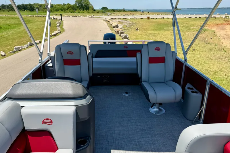 Slide: The Image of 2026 Sun Tracker Party Barge 22 RF DLX interior with seating and lake view. - 8