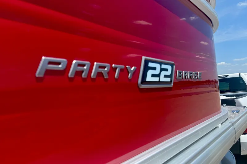 Slide: The Image of 2026 Sun Tracker Party Barge 22 RF DLX, red exterior, close-up view. - 4