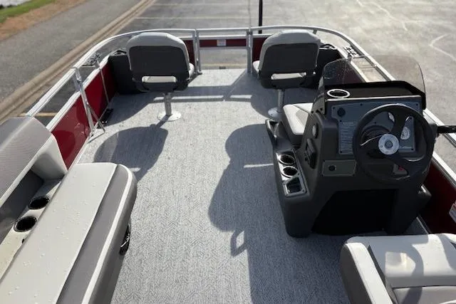 Slide: The Image of 2026 Sun Tracker Bass Buggy 18 DLX pontoon boat interior with seating and steering console. - 16