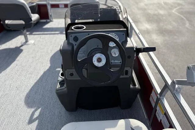 Slide: The Image of 2026 Sun Tracker Bass Buggy 18 DLX pontoon boat steering console with modern controls. - 17
