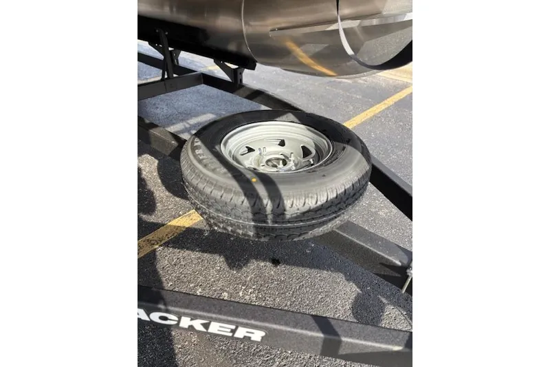 Slide: The Image of 2026 Sun Tracker Bass Buggy 18 DLX trailer with spare tire attached. - 19