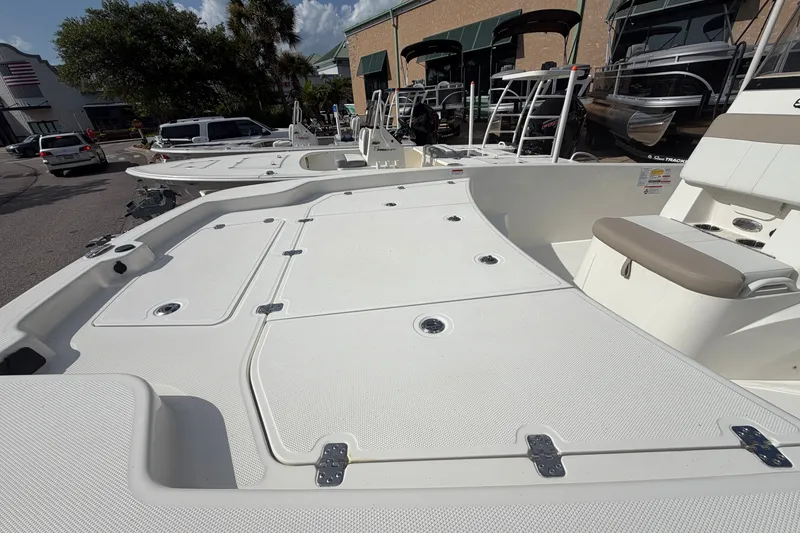 Slide: The Image of 2026 Mako Pro Skiff 19 CC boat deck with seating, displayed outdoors. - 4