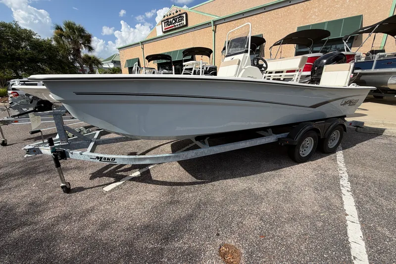 Slide: The Image of 2026 Mako Pro Skiff 19 CC boat on trailer, parked outside dealership. - 7