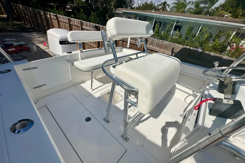 Slide: The Image of 2001 Contender 23 Open boat interior with white seating and steering console. - 35
