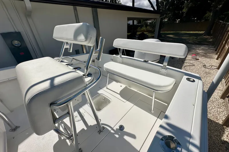 Slide: The Image of 2001 Contender 23 Open boat interior with white seating and stainless steel fixtures. - 40