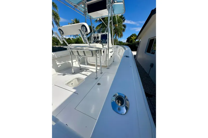 Slide: The Image of 2001 Contender 23 Open boat deck with seating, under clear blue sky. - 44