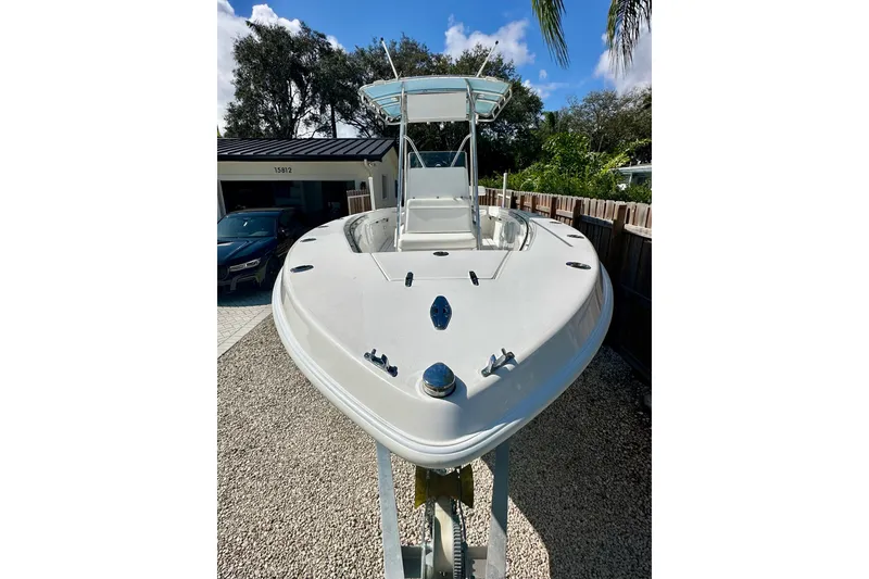 Slide: The Image of 2001 Contender 23 Open boat on trailer, parked outdoors under clear sky. - 13