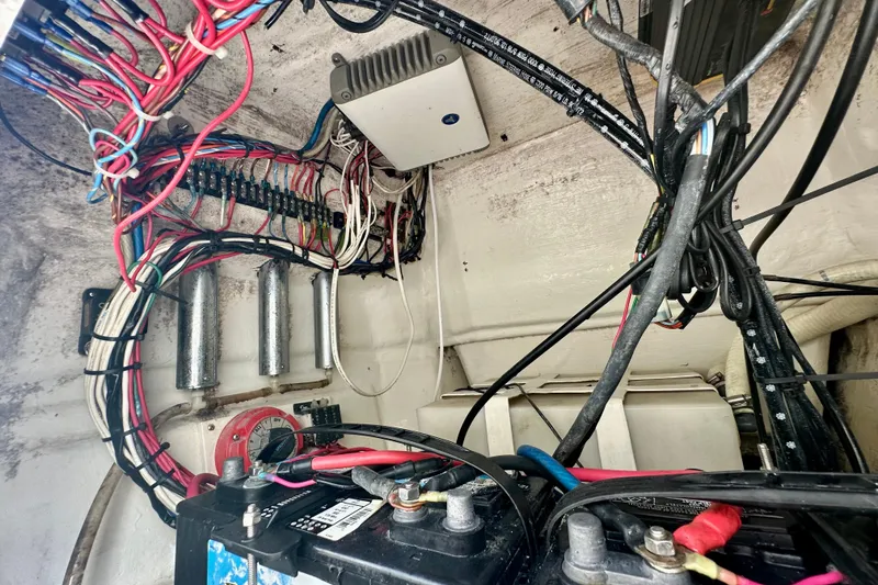 Slide: The Image of Electrical wiring and components inside a 2001 Contender 23 Open boat. - 48