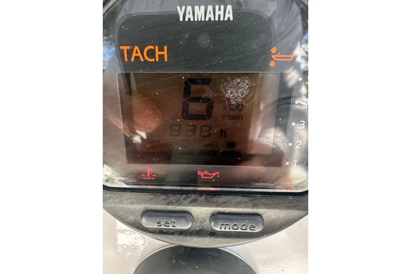 Slide: The Image of Yamaha tachometer display showing 6 RPM and 930 hours on Contender 23 Open boat. - 50