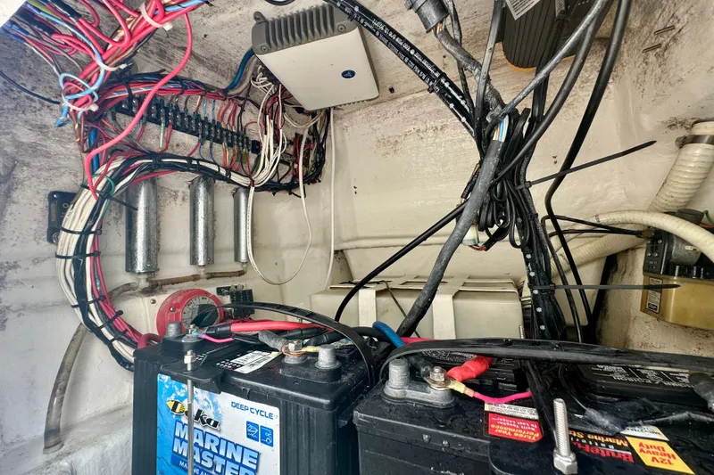 Slide: The Image of Electrical wiring and batteries inside a 2001 Contender 23 Open boat. - 49