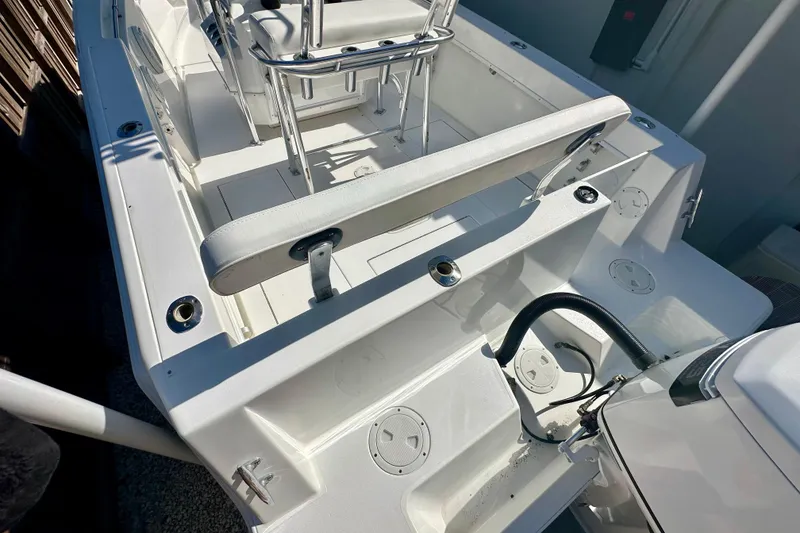 Slide: The Image of 2001 Contender 23 Open boat interior, featuring seating and fishing rod holders. - 47