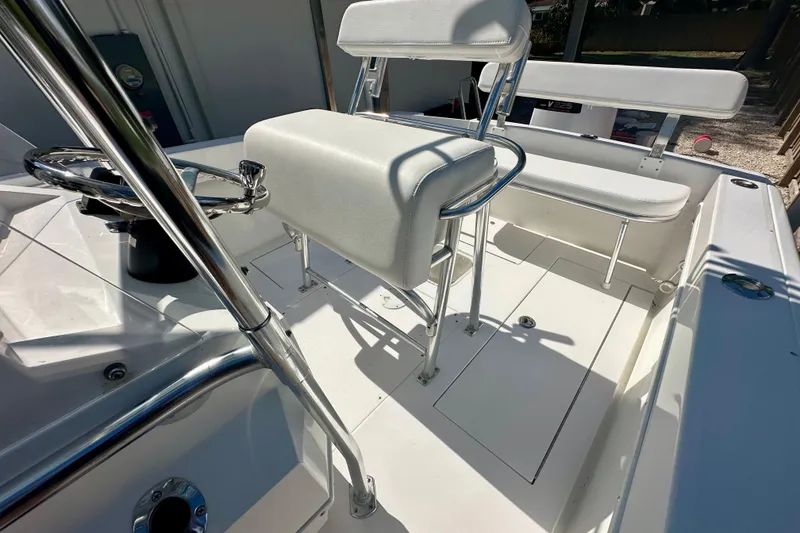 Slide: The Image of 2001 Contender 23 Open boat interior with white seating and steering wheel. - 36