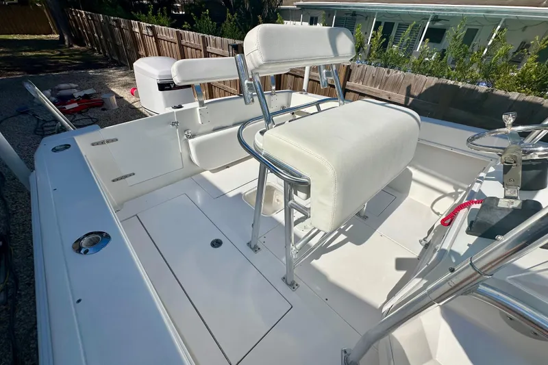 Slide: The Image of 2001 Contender 23 Open boat interior with white seating and steering console. - 33