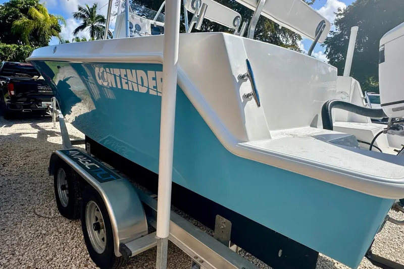 Slide: The Image of 2001 Contender 23 Open boat on trailer, light blue hull, parked outdoors. - 5