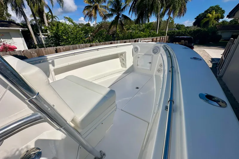 Slide: The Image of 2001 Contender 23 Open boat interior with seating, speakers, and palm trees in the background. - 18