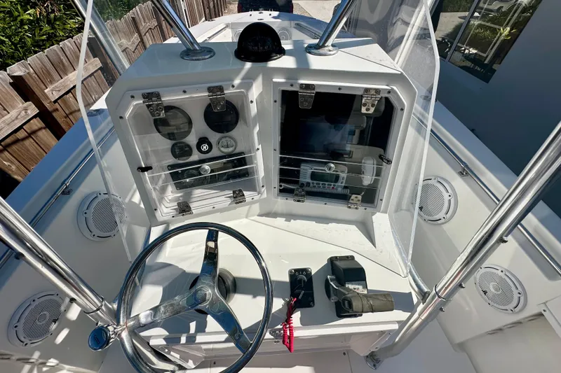 Slide: The Image of 2001 Contender 23 Open boat console with steering wheel and instrument panel. - 32