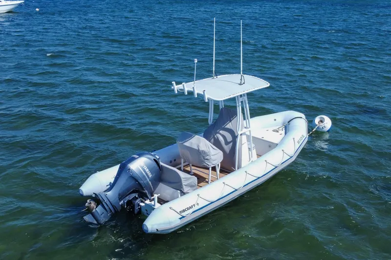 Slide: The Image of 2019 Ribcraft 6.8 boat with Yamaha engine on calm blue water. - 5