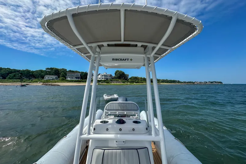 Slide: The Image of 2019 Ribcraft 6.8 boat navigating coastal waters under a clear blue sky. - 18