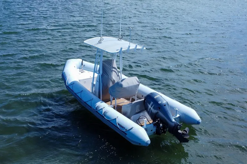 Slide: The Image of 2019 Ribcraft 6.8 inflatable boat on water with Yamaha outboard motor. - 6