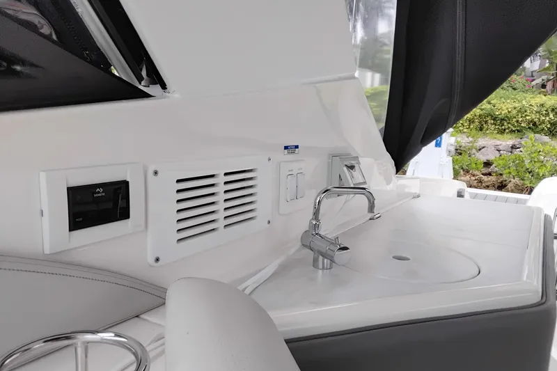 Slide: The Image of 2023 Sea Ray Sundancer 320 Outboard interior with sink and control panel. - 45