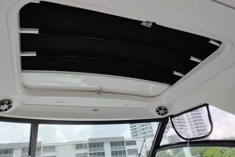 Slide: The Image of 2023 Sea Ray Sundancer 320 Outboard interior roof with speakers and sunroof. - 19