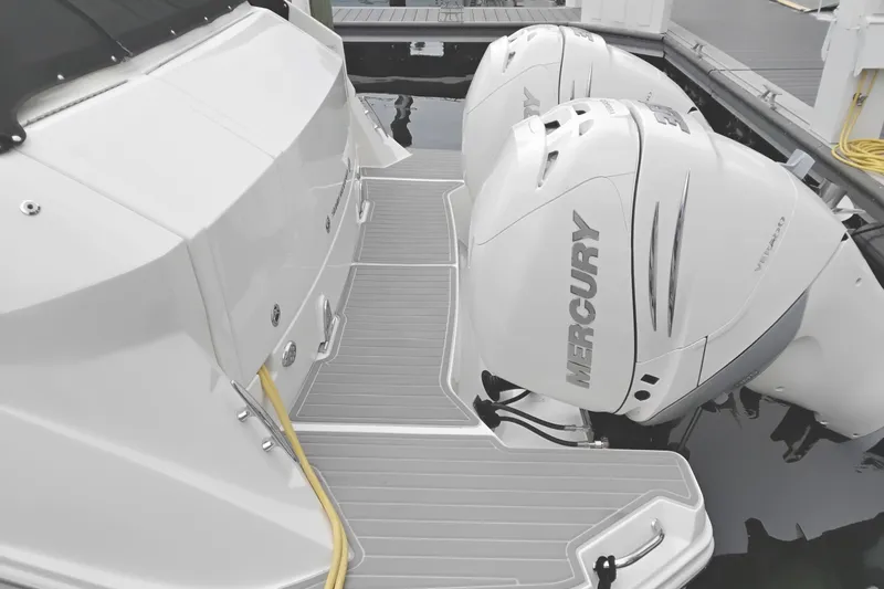 Slide: The Image of 2023 Sea Ray Sundancer 320 Outboard with dual Mercury engines at dock. - 2