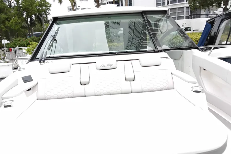 Slide: The Image of 2023 Sea Ray Sundancer 320 Outboard boat with luxurious white seating and sleek design. - 23