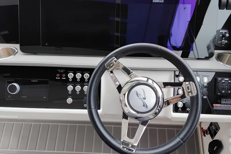 Slide: The Image of 2023 Sea Ray Sundancer 320 Outboard helm with steering wheel and control panel. - 46