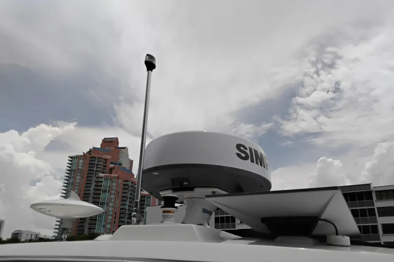 Slide: The Image of Rooftop view of 2023 Sea Ray Sundancer 320 Outboard with radar equipment against cloudy sky. - 38