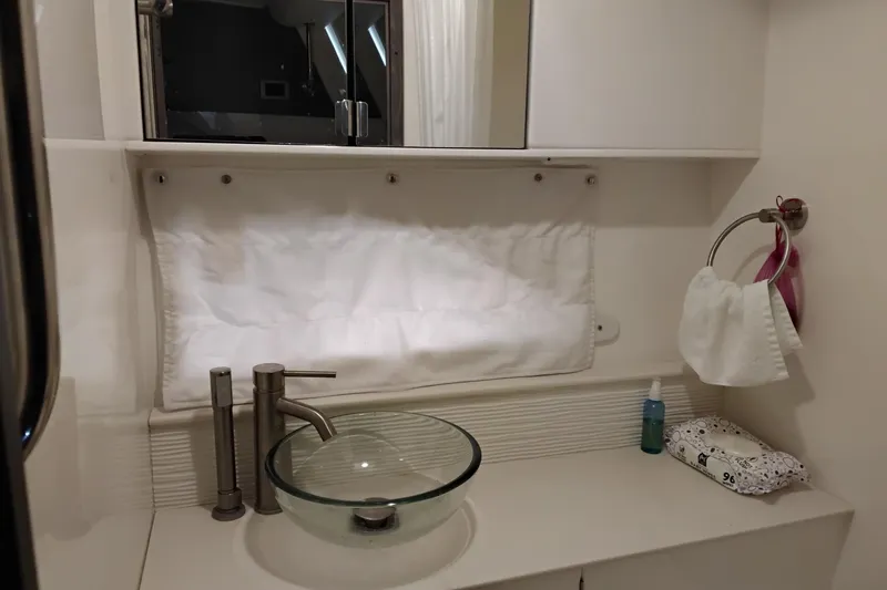 Slide: The Image of 2023 Sea Ray Sundancer 320 Outboard bathroom with modern glass sink and sleek fixtures. - 29