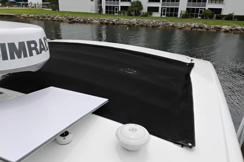 Slide: The Image of 2023 Sea Ray Sundancer 320 Outboard with Simrad radar, docked by a waterfront. - 36