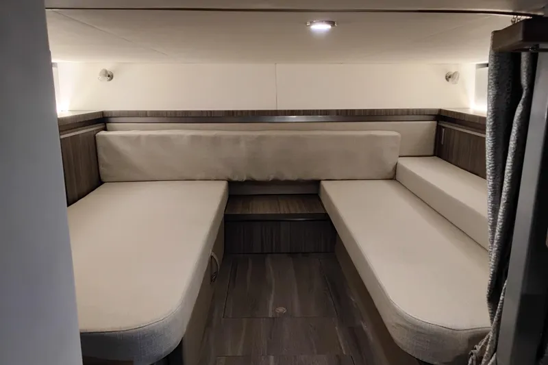Slide: The Image of 2023 Sea Ray Sundancer 320 Outboard cabin interior with cozy seating and modern design. - 32