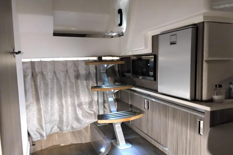Slide: The Image of 2023 Sea Ray Sundancer 320 Outboard interior with modern kitchenette and sleek design. - 28