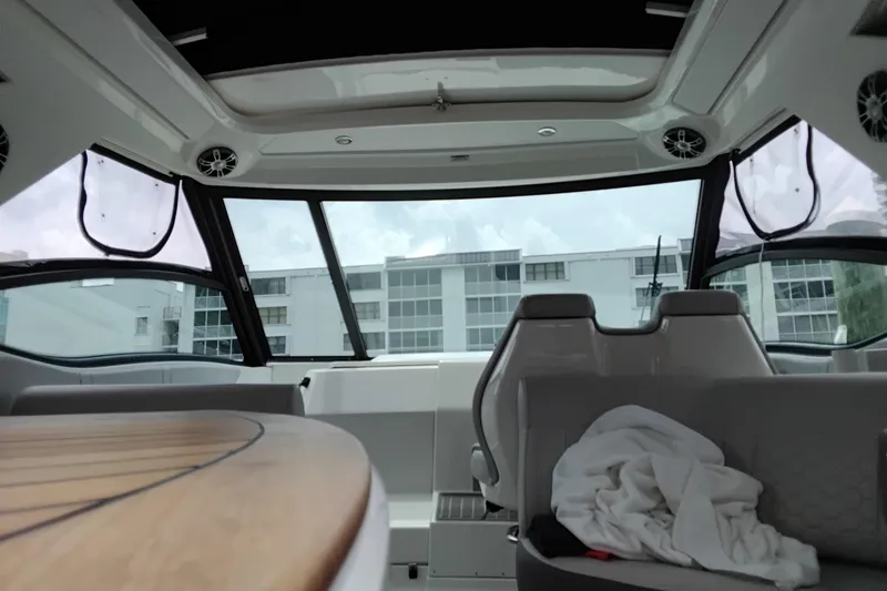 Slide: The Image of Interior view of 2023 Sea Ray Sundancer 320 Outboard, featuring seating and windows. - 14