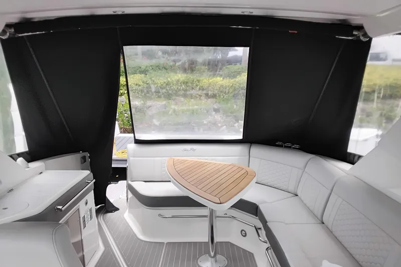 Slide: The Image of Interior of 2023 Sea Ray Sundancer 320 Outboard with sleek seating and wooden table. - 37